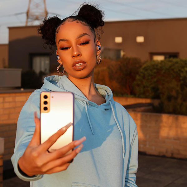 Photo of a teenage girl taking a selfie with a smartphone